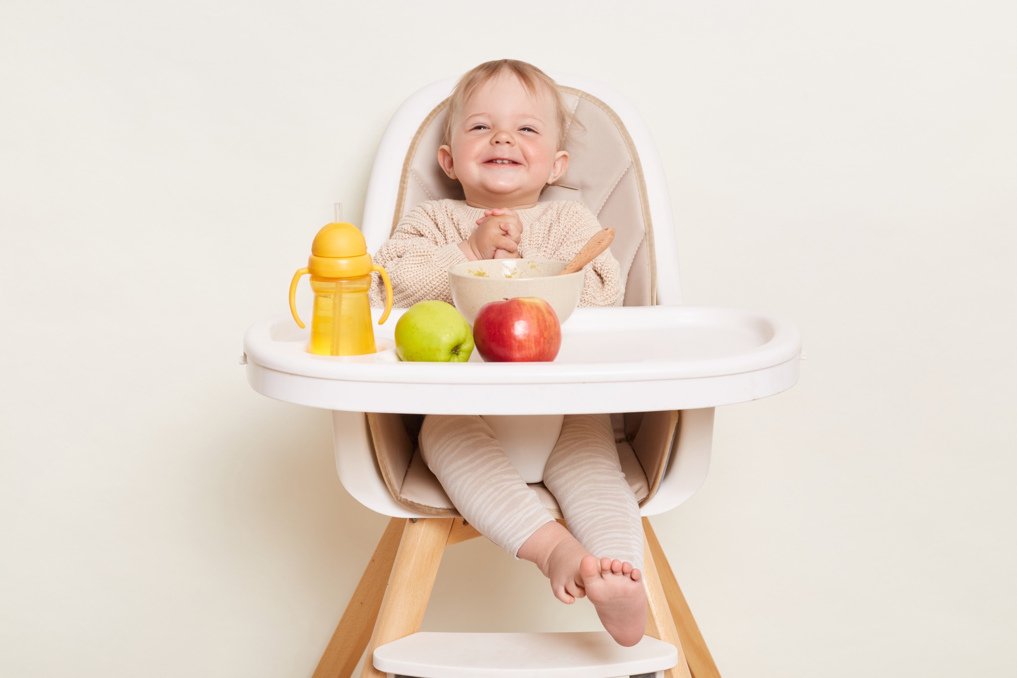 Horizontal,Shot,Of,Funny,Baby,Wearing,Beige,Sweater,Sitting,In