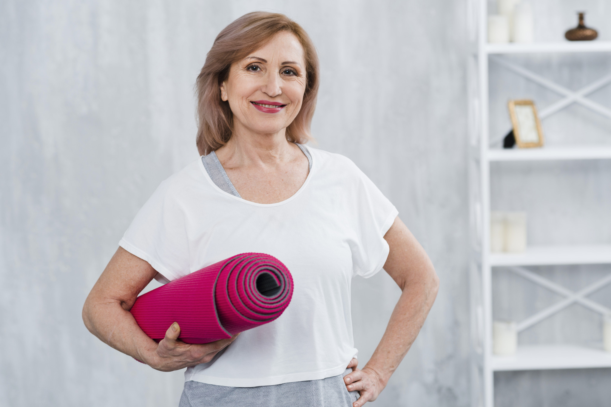 portrait-smiling-old-woman-holding-rolled-yoga-mat