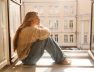 sad-fairskinned-adult-woman-blonde-warm-sweater-jeans-sitting-windowsill-sunny-day-mood-concept